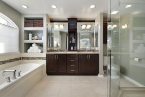 Master bath in luxury home with dark wood cabinetry